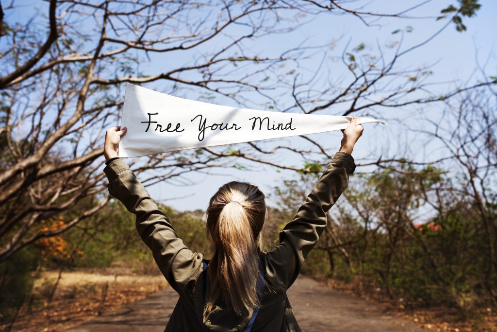 Girl holding free your mind flag banner
